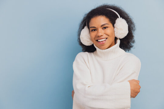 African American woman smiling wearing winter earmuffs
