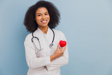 Young African American doctor holding heart showing cardiology concept