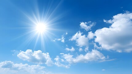 A brilliant sun bursts with light casting its rays across a vast clear blue sky populated by soft white cumulus clouds evoking a feeling of peacefulness and natural beauty
