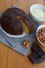 Sliced Italian traditional sweet cake called Parrozzo made with almonds and semolina on a plate on wooden table