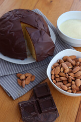 Sliced Italian traditional sweet cake called Parrozzo made with almonds and semolina on a plate on wooden table