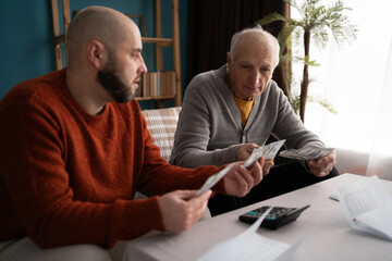 adult son lends money to his Elderly father deal with financial problems.
