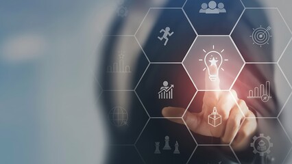 Ideas Unleashed: A person's hand interacts with a digital hexagonal interface, highlighting the central theme of innovation and problem-solving. It's about strategic insights, innovative thoughts.