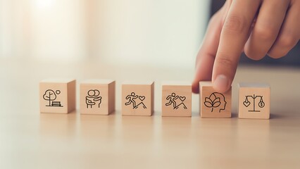 Conceptualizing the Future: A hand carefully selects a wooden block adorned with an environment-themed icon. The image symbolizes a commitment to sustainability, mindfulness.