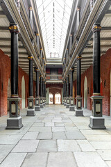 Naklejka premium Historic gallery with columns under glass roof. Atmospheric city passage.
