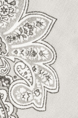 Cloud Dancer paisley pattern on a light gray textile background
