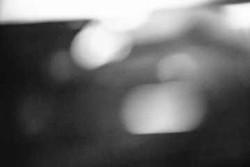 retro film overlay effect with scratch dust and light leaks,retro grain noisy film distressed texture light leak flare black background,old film background,grunge black and white background with ray