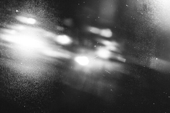 retro film overlay effect with scratch dust and light leaks,retro grain noisy film distressed texture light leak flare black background,old film background,grunge black and white background with ray