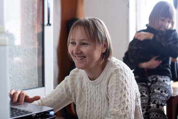 mother with daughter at home working on laptop, lifestyle people concept
