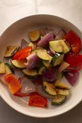 roasted zucchini, red pepper and red onion chunks, charred edges and glossy olive sheen, warm rustic plating for side dish