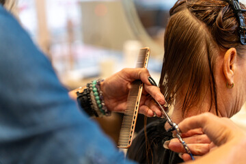 Hairstylist Measuring Hair Length During Haircut