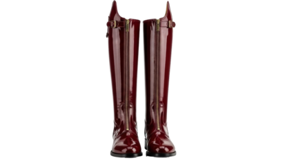 Isolated pair of women's shiny patent leather boots for riding or fashion, no background