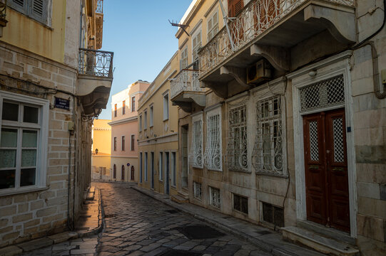 Beautiful venetian architecture of a limestone paved street in Ermoupoli on the Greek island of Syros