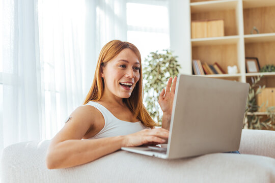 Happy Woman Working From Home On Laptop, Waving Hello During Online Video Call At Home Office - Powered by Adobe