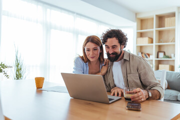 Couple Working Together At Home Office, Laptop Open, Coffee In Hand, Feeling Positive And Connected