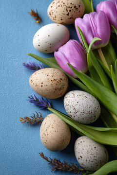 Spring-inspired layout with tulips and speckled eggs arranged along a soft blue backdrop