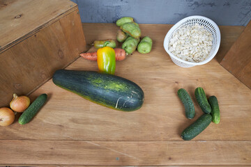 Autumn harvest, vegetables and fruits lie on a wooden table.