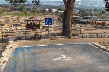 Accessible parking bay with wheelchair sign at Sepphoris Zippori National Park in Galilee Israel, overlooking archaeological ruins and paths, inclusive tourism and mobility access 