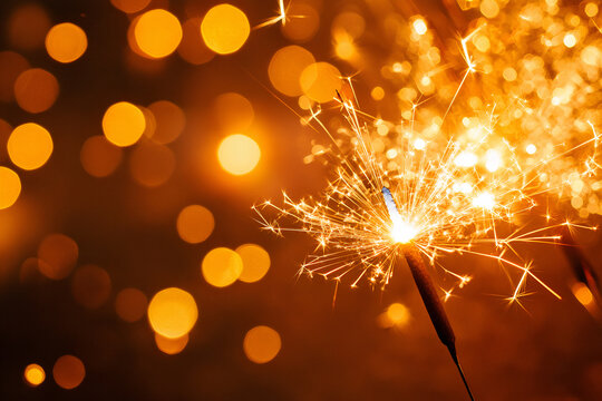 Sparkler on a golden background - Christmas Celebration