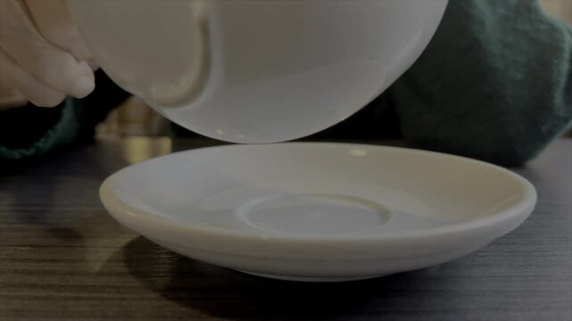 Older person drinking from a cup and saucer coffee or tea close up and slow motion 120fps UK 4K