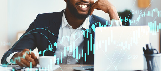 In a modern office, a cheerful african american employee sits at his desk, sipping coffee while engaging with his laptop. The atmosphere is vibrant, reflecting productivity and positivity.