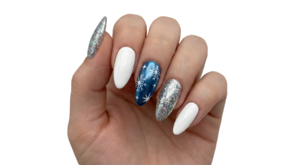 Female hand showcasing a festive winter manicure featuring white silver glitter and blue snowflake nail art on long pointed nails isolated on white
