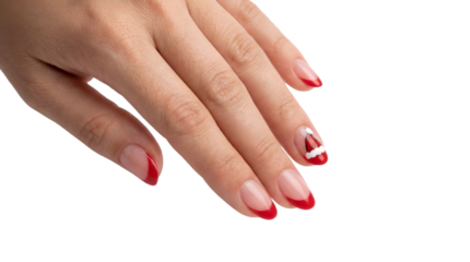 Female hand with festive red tipped French manicure and a cute Santa hat nail art design perfect for Christmas and holiday beauty concepts