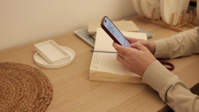 Closeup video of a young woman doom scrolling a smartphone. Addictive behaviour. Modern world problem. Social media marketing. Working through smartphone.