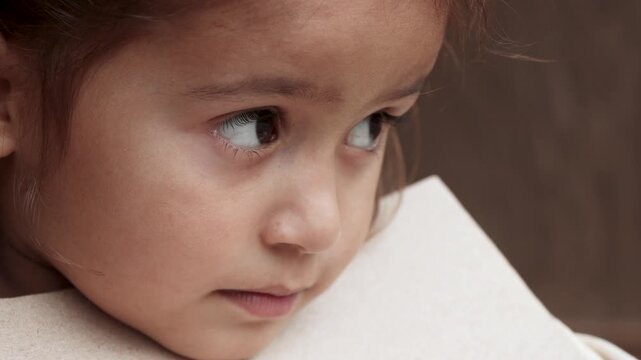 Close-up portrait of an adorable young village girl focusing on her studies with a notebook