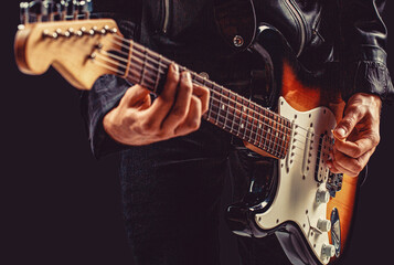 Obraz premium Electric guitar, guitarist, musician rock. Man playing guitar. Hands of a musician playing the electric guitar