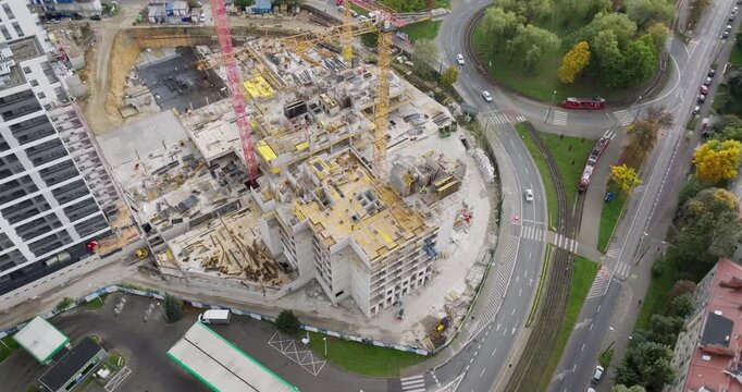 Wide drone view of ongoing apartment construction in Katowice, Poland. Active site symbolizing strong housing demand and dynamic building sector in Poland and the European Union.