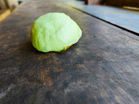 soft steamed buns filled with coconut enten on a wooden board
