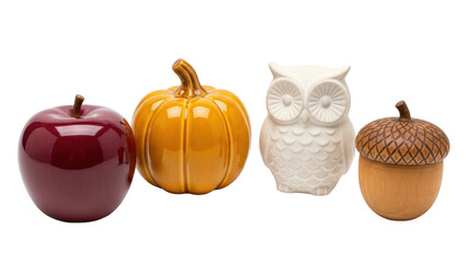 Isolated Autumn decor arrangement of a red apple, orange pumpkin, owl figure, and acorn nut object © Dennis