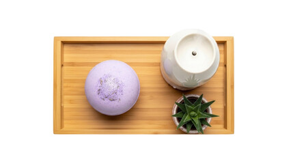 Isolated still life featuring natural spa products including a bath bomb and succulent on a tray