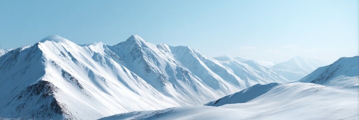 Majestic snow-covered mountain range under clear blue sky