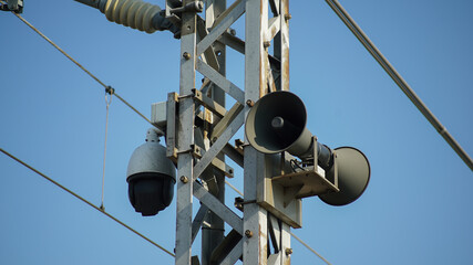 Surveillance cameras and loudspeakers on steel structures