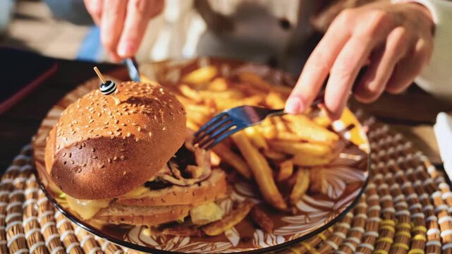 Gourmet burger served on a patterned plate in bright daylight, with blurred restaurant terrace in the background