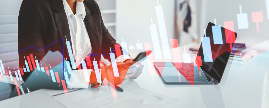A happy black businesswoman is focused on her laptop and smartphone in a bright, stylish office. She sits in front of a blank computer screen, ready for future projects and designs. - Powered by Adobe