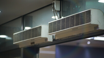 Two indoor wall-mounted air conditioners installed side by side