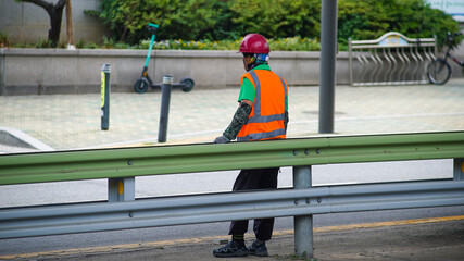 Walker resting against a barricade during road construction