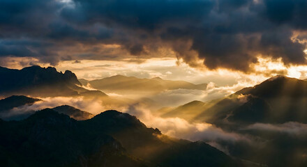 Obraz premium Dramatic Mountain Valleys with Sun Rays and Misty Clouds