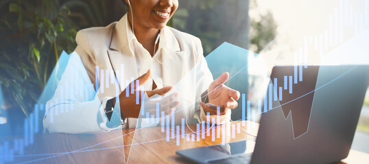 A business professional in a white suit actively participates in a virtual meeting. Financial graphics overlay the scene, enhancing the modern office atmosphere. Gestures indicate engaging discussion.