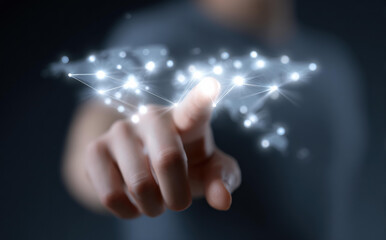 Focused hand touches global network connection on digital world map. concept for future of technology, internet, and international business