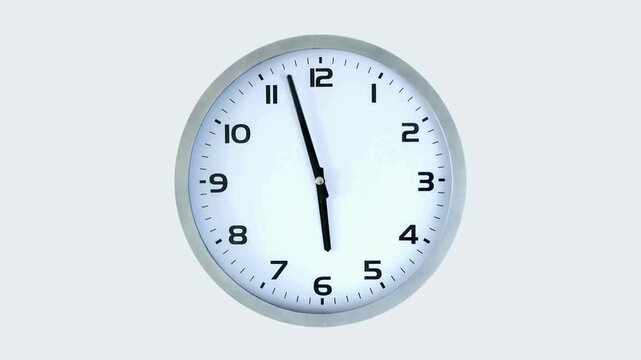 Minimal silver-framed wall clock with black numerals and slender hands against a pale blue backdrop