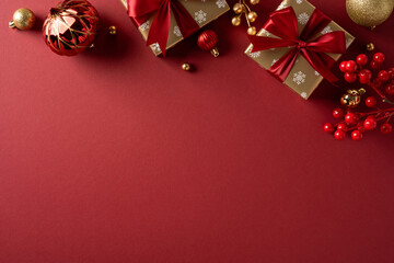 Red festive background with wrapped gift, ornaments, and berries conveys warm holiday spirit...