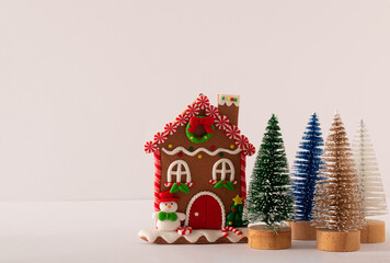 Gingerbread house and colorful trees isolated on a white background. Christmas holiday concept.