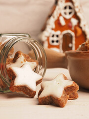 Tasty organic cinnamon stars on a wooden table with Christmas decoration