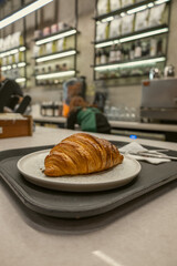 Fresh Croissant on Plate in Modern Cafe Interior