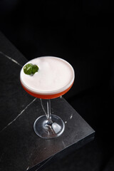 A delicious alcoholic cocktail at the bar. The bartender prepares cocktails