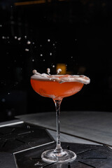 A delicious alcoholic cocktail at the bar. The bartender prepares cocktails